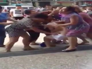 Woman being stripped in public